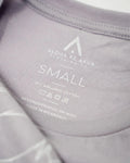 Pop-Up Mākeke - Aloha Ke Akua Clothing - Mai Hopohopo Women's Short Sleeve T-Shirt - Lavender Dust - Tag Close Up