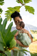 Pop-Up Mākeke - The Keiki Department - Bamboo Muslin Baby Swaddle Blanket - Ulu Green Ulu o Lele - In Use